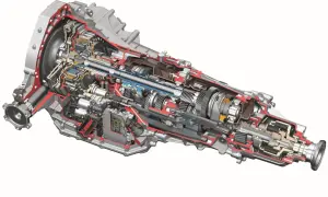 Przekrój automatycznej skrzyni biegów z widocznymi trybami, wałkami i elektroniką. S tronic to zaawansowana technologia.