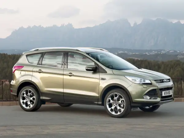 Złoty Ford Kuga 2 na tle górskiego krajobrazu.